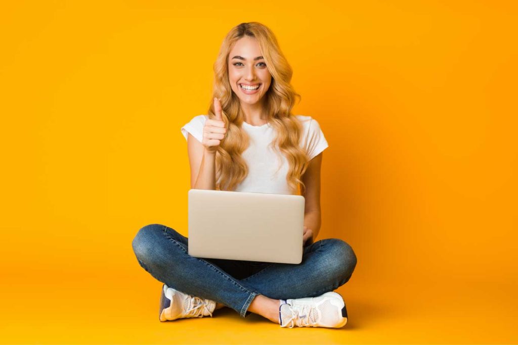 Cyber Security - Woman with a laptop all safe and sound with yellow background