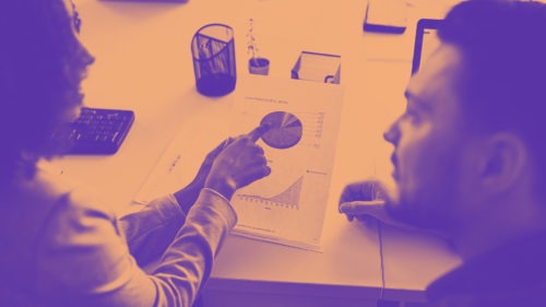 Colleagues working together at a desk on innovation projects