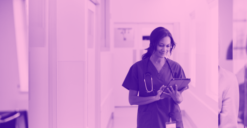 A female medical professional checks her phone