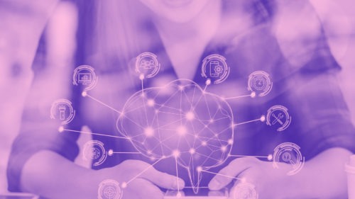Hands holding image representing technology on a purple background