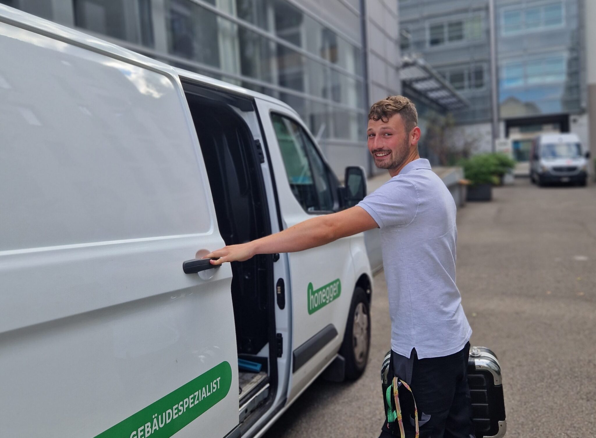 Honegger AG frontline staff opening a van door